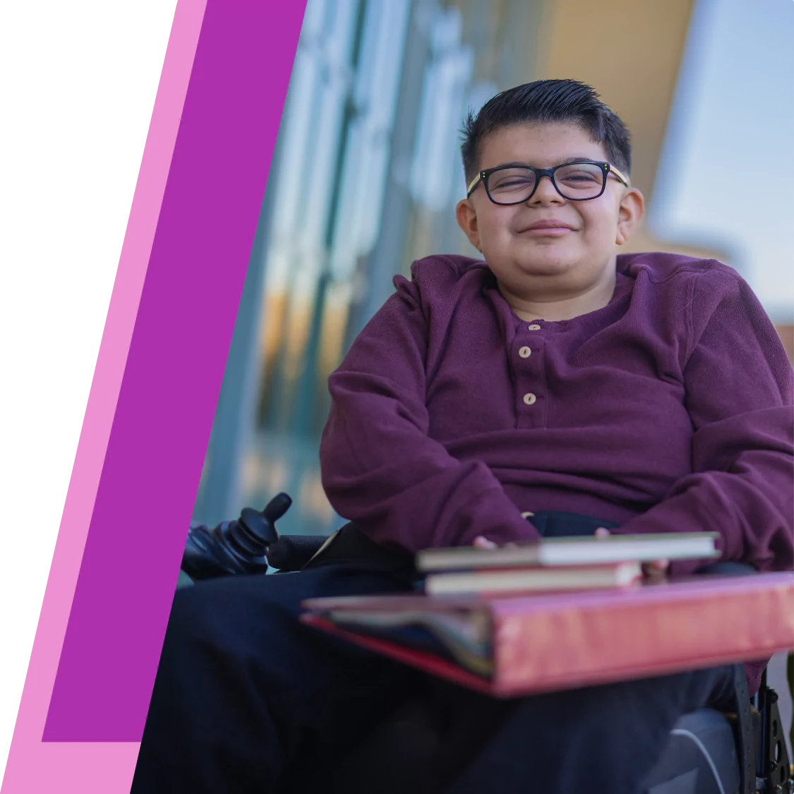 Disabled boy in wheelchair smiling at the camera